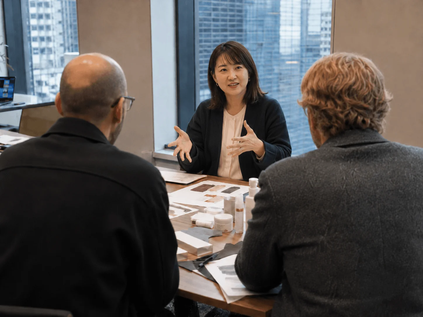 A working session reviewing packaging and brand materials with a client in Tokyo