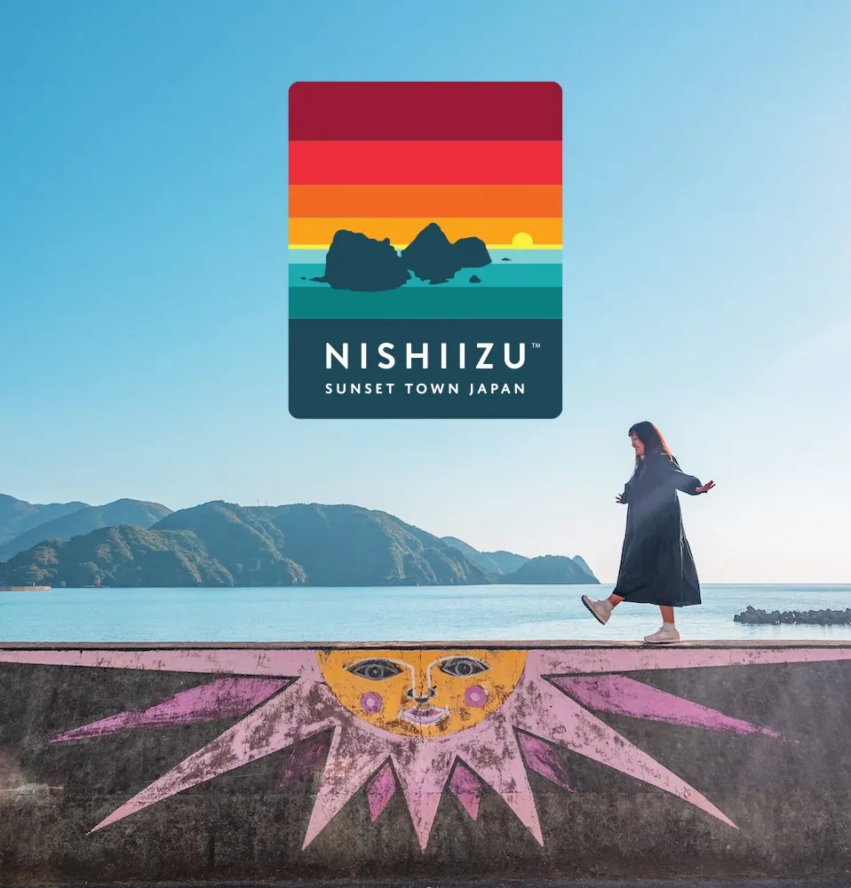 Nishiizu identity over coastal photography with sun mural
